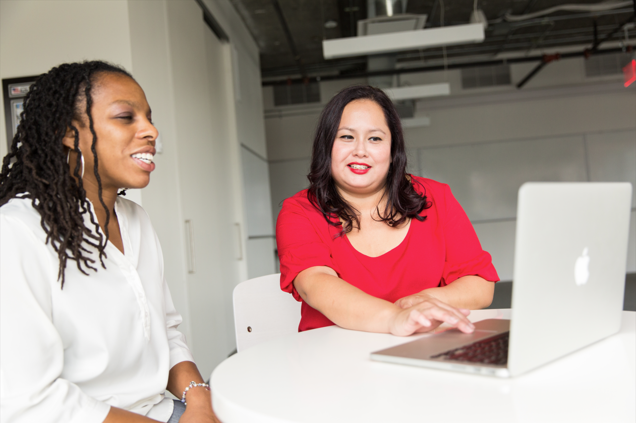 two women looking at a laptop screen